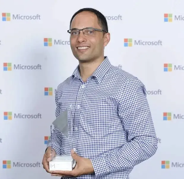 Marlon Marescia holding the Microsoft Partner Award for Best Partner Education