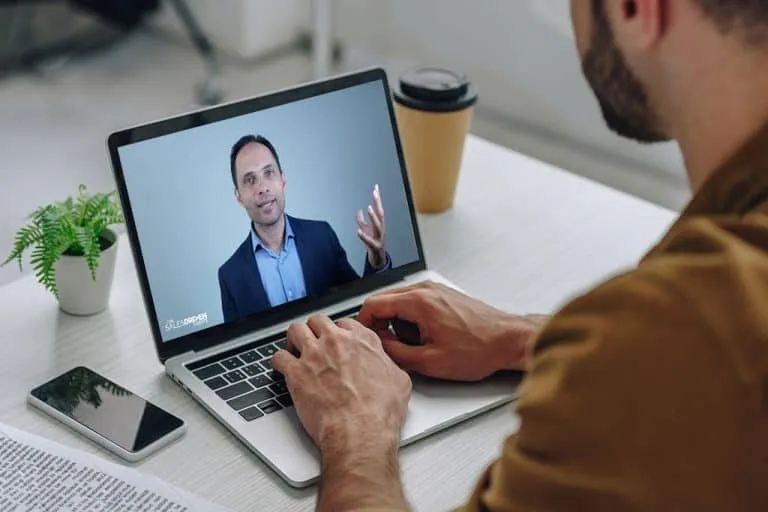 Watching the video training on a laptop at a desk